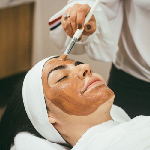 A facial treatment is underway as an esthetician applies a tool to a client&rsquo;s face in a spa.